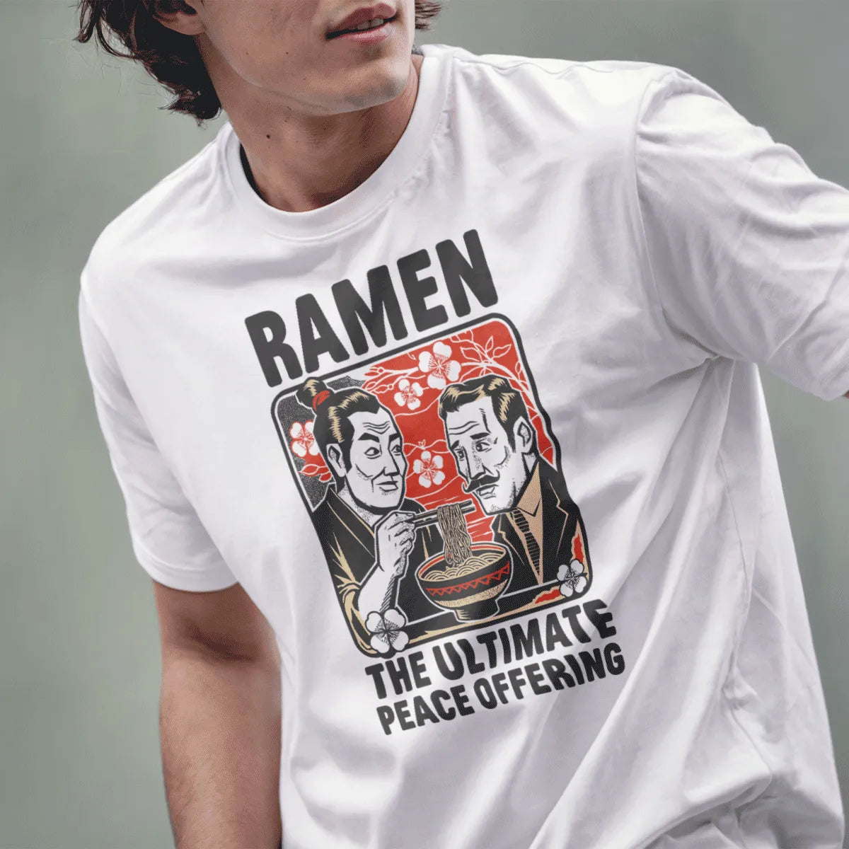 Male model in white t-shirt with ramen peace design, cherry blossoms, and friendship theme.