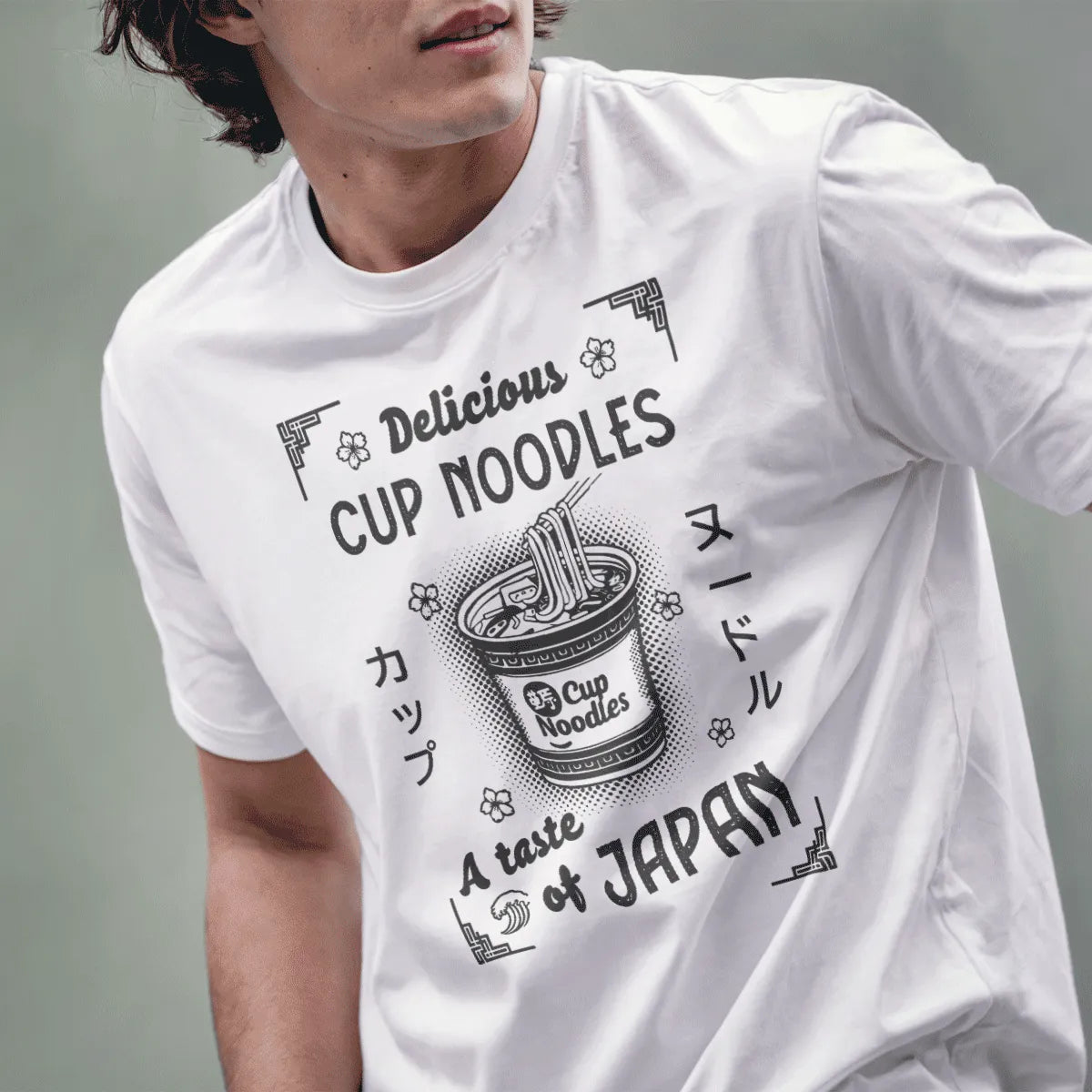 Male model in white cup noodles t-shirt with playful “Delicious” text and ramen cup, japanese shirts, kawaii clothes.