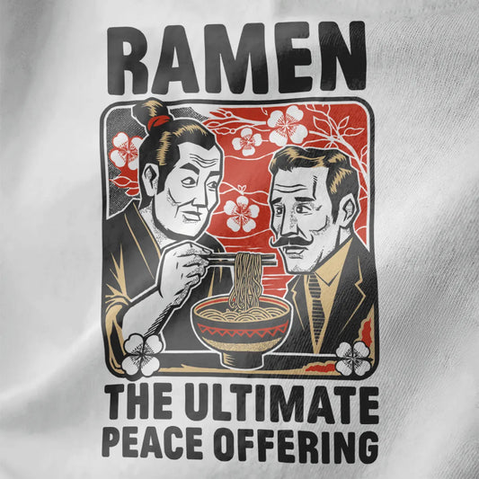 Close-up of ramen peace design on white fabric, featuring cherry blossoms and bold blocky text.