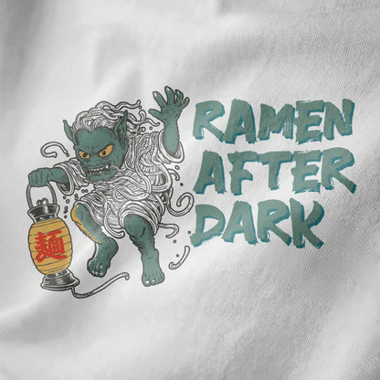 Ramen yokai t-shirt closeup on white, whimsical monster with noodles, lantern, and bold text fonts.