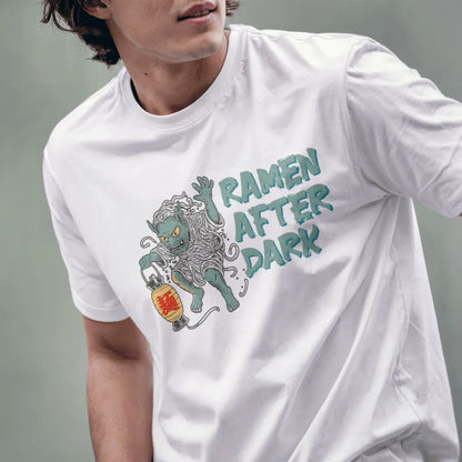 Male model in white ramen yokai t-shirt, playful monster sushi, lantern, and contrast in colors.