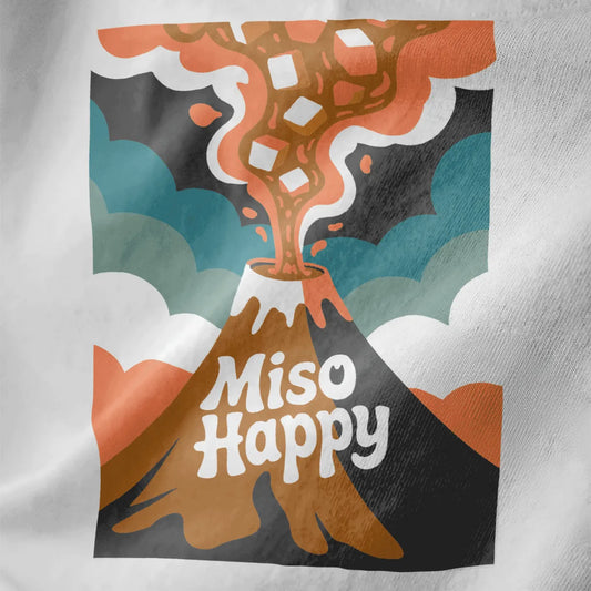 Stylized volcano with miso soup eruption and tofu cubes on white shirt, retro font, warm palette, japanese t-shirts.