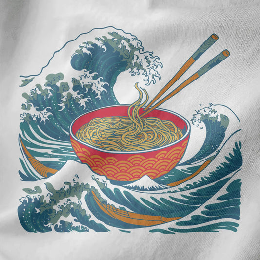 Close-up of white t-shirt fabric with red ramen bowl, golden seigaiha waves, and dynamic blue ocean design.
