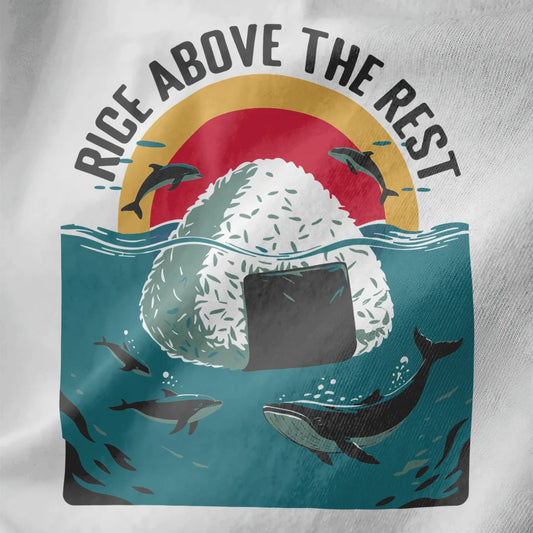 Close-up of white t-shirt fabric with giant onigiri, textured rice grains, and dolphins leaping above ocean waves.