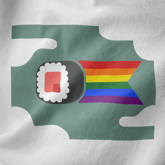 Close-up of sushi roll with rainbow ribbon on white fabric, kawaii sushi, inclusive design, soft aesthetics.