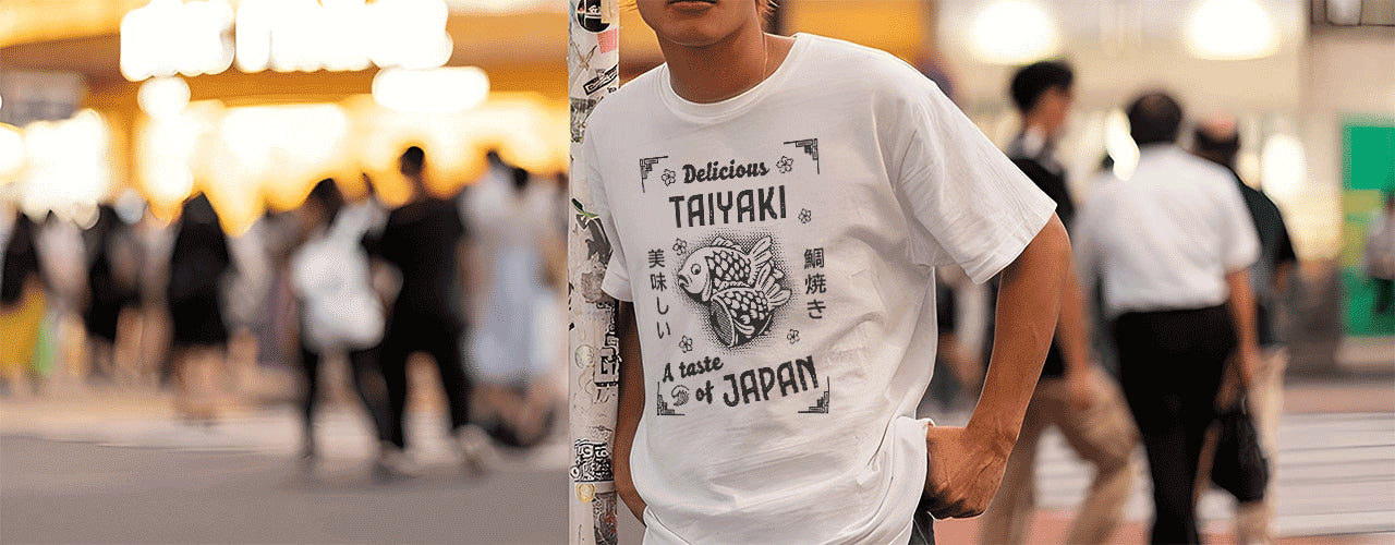 Asian-looking male standing by a pole, wearing a white graphic t-shirt featuring Japanese food from WAKUWAKUMA.